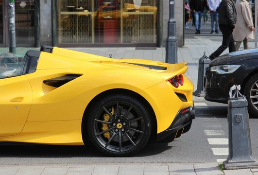 Yellow Ferrari Supercar F8 Tributo In Motion driving the Streets of Coastal Germany