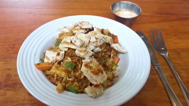 Grilled chicken on rice vegetables and chipotle sauce dish meal.
