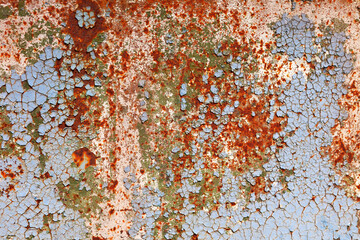 Surface with peeling blue paint and rust