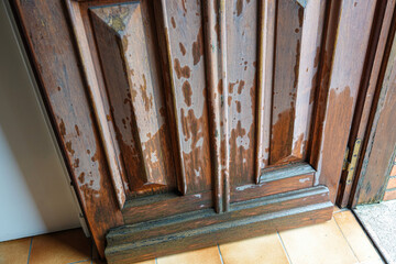 open wooden door covered with splashes of rain