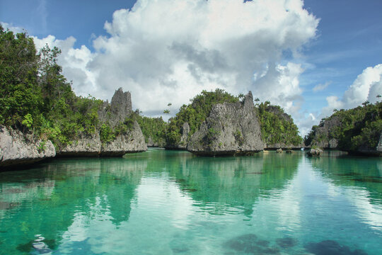 Limestone outcrops and island in the shallow sea of Raja Ampat, Misool area in Indonesia