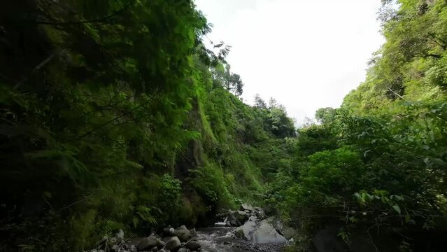 flying an fpv drone on a river and waterfall