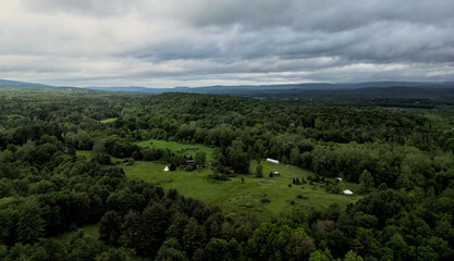 sunset view of a farm as the sun is setting (view of catskill mountains in upstate new york catskills) beautiful spring nature colorful trees landscape with farmstead yurt home scenic sky dusk