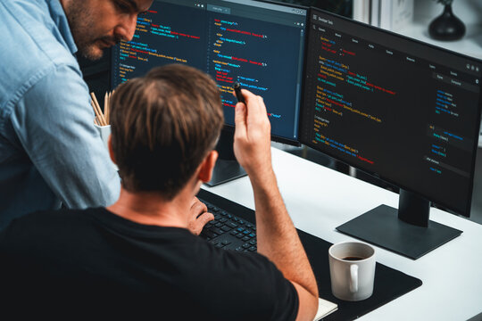 IT developers discussing online software development information on pc screen, creating program coding for latest version application on website. Concept of brainstorming firmware updated. Sellable.