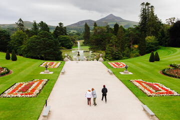 people walking in the park with hills in background