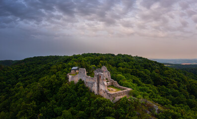 Naklejka premium Aerial panoramic view about castle of Rezi, Hungarian name is Rezi var. This outstanding tourist attraction of Rezi built in the 1300s, which stands on the dolomite ridge of Meleg-mountain.
