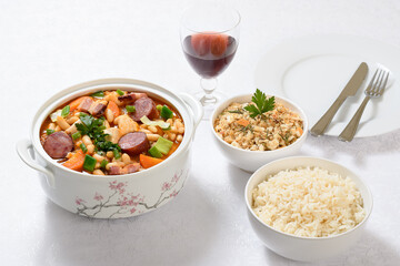 a bowl with chicken cassoulet on a white table