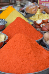 Different spices displayed in metal bowls in street market at Jodhpur