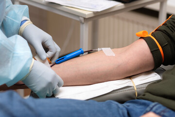 man donor for bone marrow donation blood in laboratory. male hand holding red ball, prevention of...