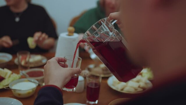 Pour compote from a carafe, pour juice from a carafe