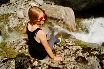 A hiking woman on a rock