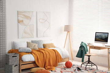 Teen's room interior with modern furniture and beautiful pictures on wall