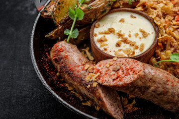 Fried sausages with spices and fried potatoes