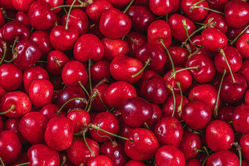 ripe cherries in a plastic box on the table top view background