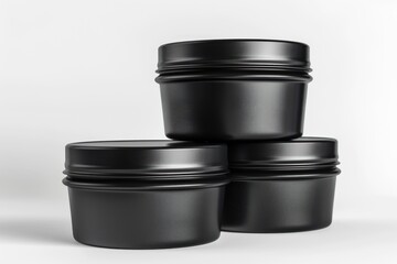Three Black Metal Jars on a White Background