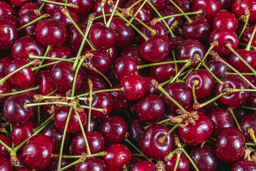 Ripe cherry in a plastic box on the table top view and side background