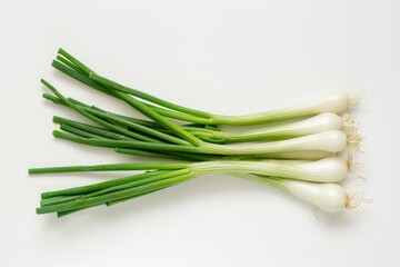 A cluster of scallions and fresh chives set against a white backdrop