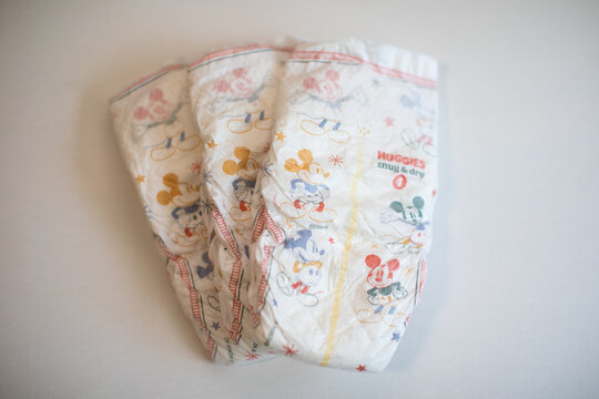 Three huggies diapers on a white background 