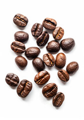 a pile of coffee beans on a white surface