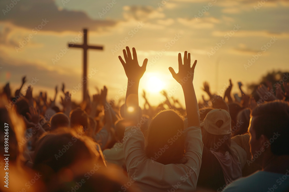 Wall mural a crowd of people raising their hands in front of a cross