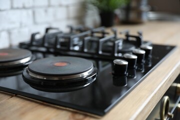 New modern stove with gas and electric burners in kitchen