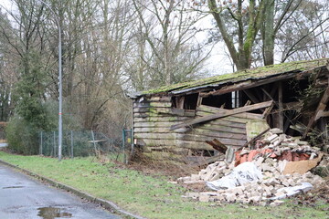 Dilapidated structure overgrown with vegetation. Keywords abandoned, decay, rustic