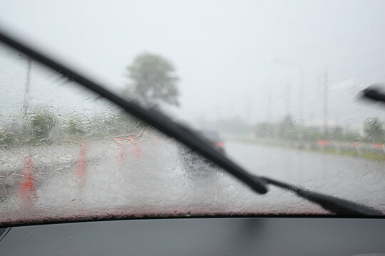 car on highway road with rainny season, blurred image