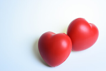 two red stress ball isolated on white background, heart shape toy