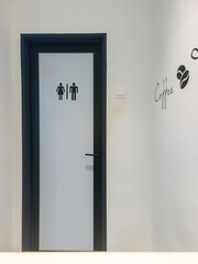 Ladies room and mens room. Closed toilet doors with printed marks.