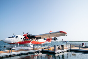 Fototapeta premium Woman with a seaplane background before boarding.