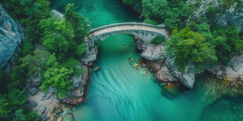Obraz premium Stone Arch Bridge Over Turquoise River