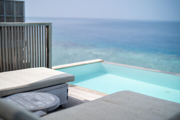 Beautiful terrace of water villa with pool in Maldives.