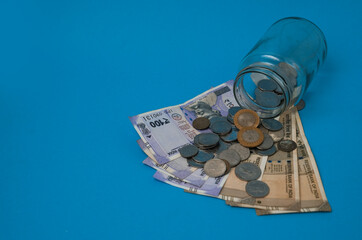 Increasing coins in a three glass jar against a light blue background. Savings money concept, growth, income, investment, Business success, indian rupee, coin, Sip, investing