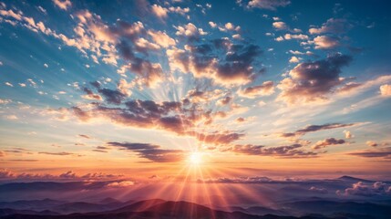 Obraz premium Sunset Over Mountain Range with Dramatic Clouds