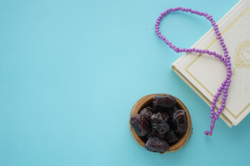 Holy book Quran and rosary on table, close up.