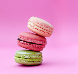 Macaroons, baked candy and stack of French sweets with variety, delicacy and treats on pink background. Dessert, luxury and different flavors of confectionery for bakery, fine dining and cookies