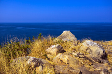 Rock and blue sky sea way to Krating cape in summer Phuket Thailand