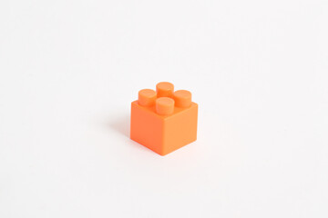 Orange Plastic toy blocks isolated on white background. Building Blocks