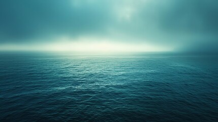 Obraz premium Tranquil ocean scene with a misty, ethereal sky.