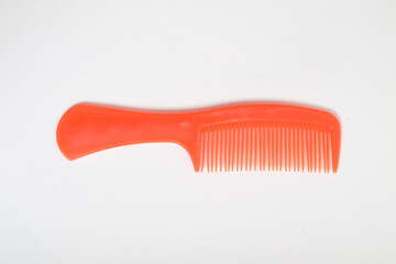 Red colored Plastic Hair Comb isolated on white background