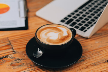 Closeup of coffee cup on table in empty corporate conference room before business meeting in office