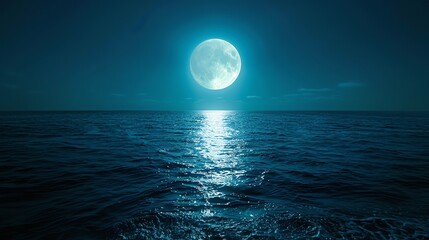 Fototapeta premium Full moon reflecting on the ocean waves at night.
