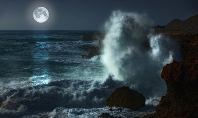 Night, moon and waves in ocean for landscape, natural beauty or peace with environment. Dark, sea and rocky coastline with planet glow or energy in summer, water storm on vacation in Mauritius