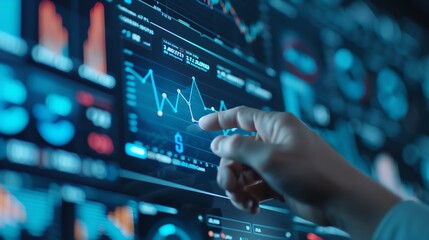 Obraz premium Hand analyzing financial data on digital screen, illustrating stock market trends, business analytics, and modern technology in finance.