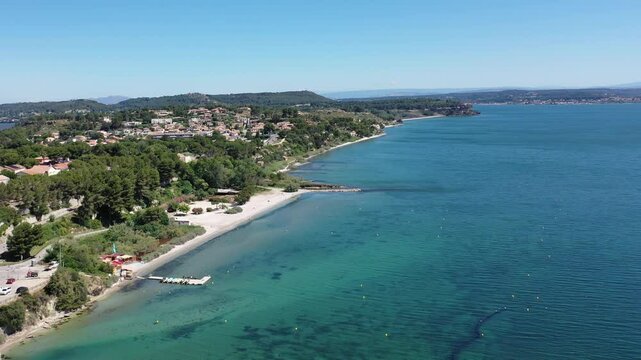 Aerial view drone video flying from the air over the picturesque sea coast of the south of France, Provence, Istres at bright sunny summer day