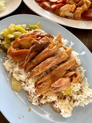 Vertical photo set of that street food, pork leg with rice, crispy and red pork on dish.