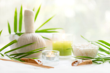 Thai Spa Treatments aroma therapy salt and  sugar scrub massage with bamboo leaves with candle, white background. Thailand. Healthy Concept