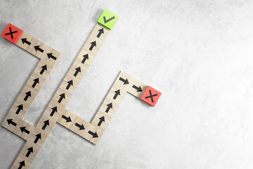 Blocks with arrows forming a path, one with a green check mark, another with a red cross, depicting...