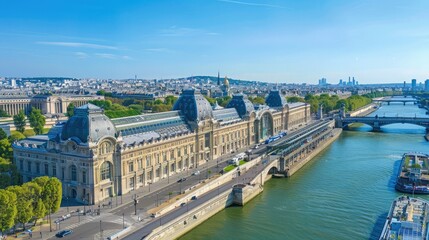 Obraz premium A stunning view of a historic building along the Seine River in Paris, France, with a clear blue sky and cityscape in the background.