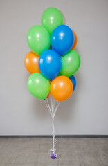 a bunch of blue and orange helium balloons on a white background